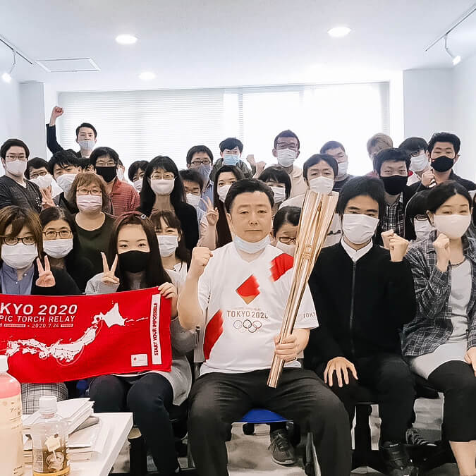 HLサポートの社長と職員と利用者の集合写真